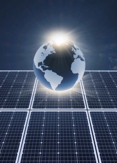 Solar panels and globe against blue sky and sun