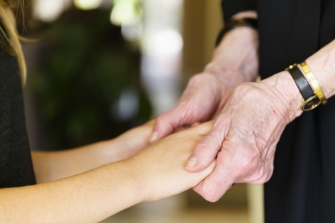 Close-up of grandmother and granddaughter (8-9) holding hands