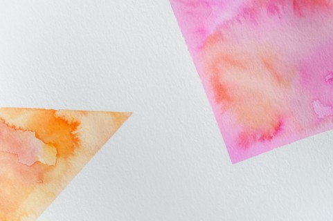 Close-up of watercolor colorful abstract shapes on white background