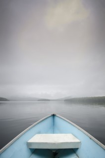 View from rowboat on foggy lake