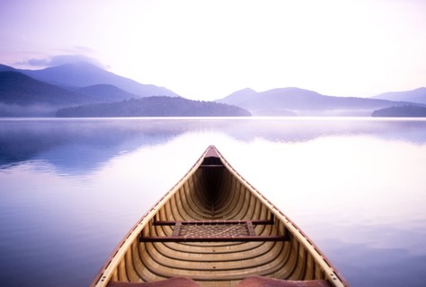 View of Whiteface Mountain from wooden canoe on Lake Placid