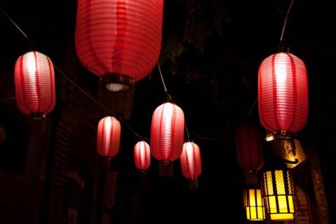 Paper lanterns on city street at night