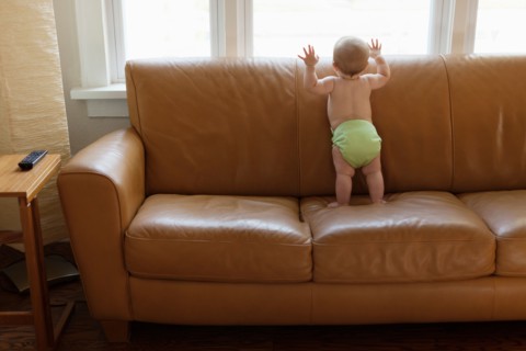 Baby boy playing on sofa