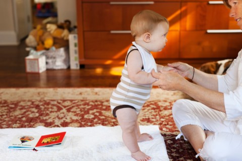 Mother and baby son playing on carpet