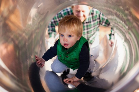 Boy climbing up slide in playground