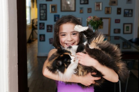 Girl holding pet cat