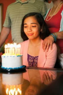 Girl looking at birthday cake