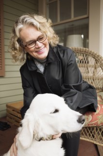 Senior woman sitting in porch with dog