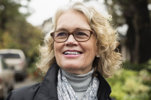 Portrait of contented senior woman on driveway