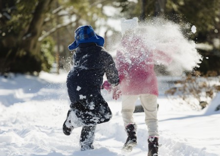 Two children running in snow