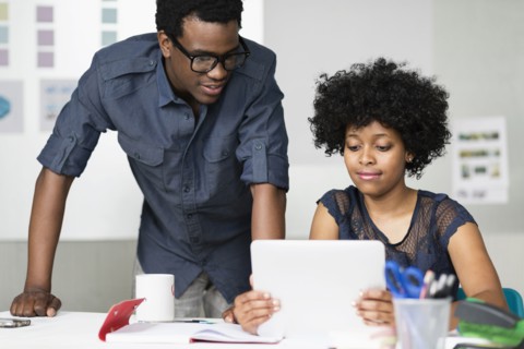 Two colleagues working with digital tablet