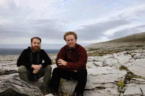 Two men sitting on rocks