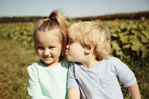 Boy kissing girl on cheek