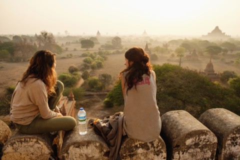 Women relaxing on stone wall