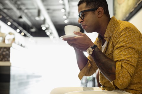 Young man drinking coffee in coffee shop