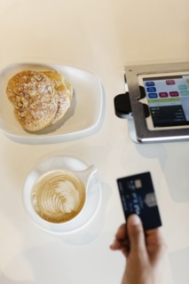 Customer paying for coffee in coffee shop