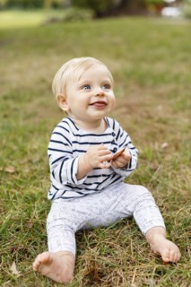 Portrait of baby girl sitting on grass