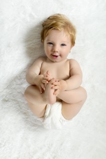 Toddler lying on blanket