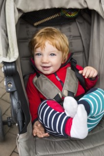 Toddler sitting in pushchair
