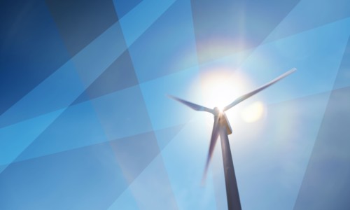 Wind turbine against sky and sun