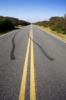Tire tracks and double yellow line on empty road