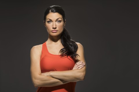 Studio portrait of athletic woman in red sleeveless top