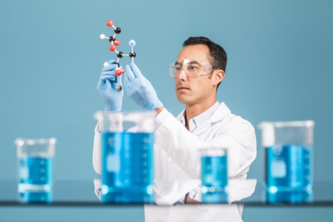 Scientist holding molecule model
