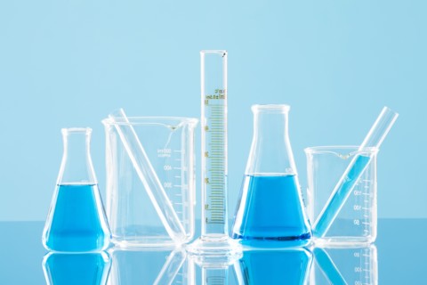 Laboratory glassware against blue background