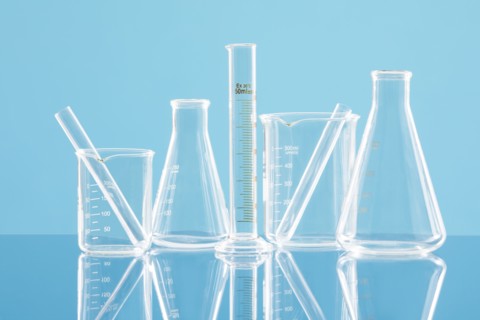 Laboratory glassware against blue background