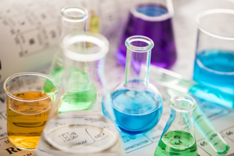 Laboratory glassware with liquids on periodic table