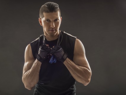 Portrait of muscular man wearing sports gloves