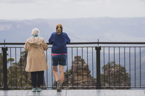 Rear view of two women standing together