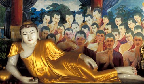 Reclining Buddha statue and paintings in Buddhist temple