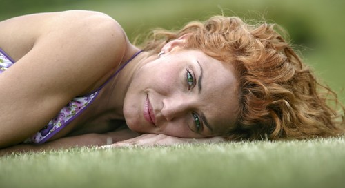 Young woman lying on grass