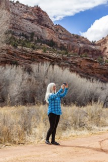 Woman taking pictures while hiking in Grand Staircase-Escalante National Monument