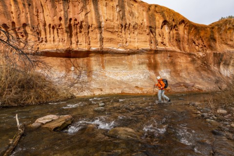 Woman wading across Escalante River in Grand Staircase-Escalante National Monument