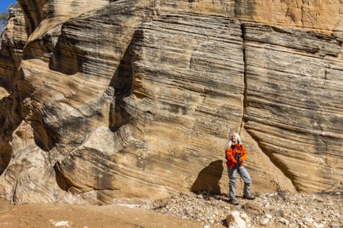 Woman hiking in slot canyon in Grand Staircase-Escalante National Monument