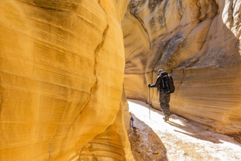 Man hiking in slot canyon in Grand Staircase-Escalante National Monument