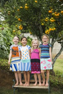 Smiling girls standing on bench