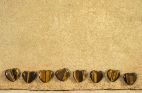 Wooden hearts on beige background