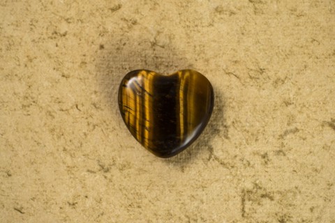 Wooden heart on beige background