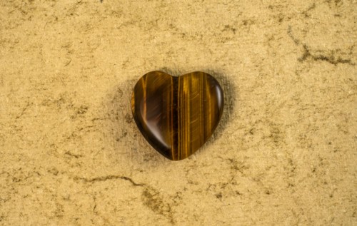 Wooden heart on beige background