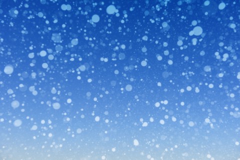 Falling snow against blue background
