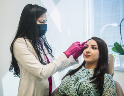 Patient receiving injection on her face
