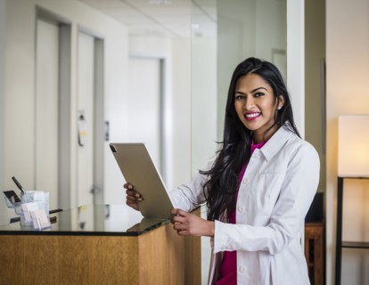 Portrait of female doctor at reception desk