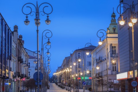 Poland, Holy Cross, Kielce, City street illuminated at night