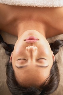 Close-up of woman with eyes closed on massage table