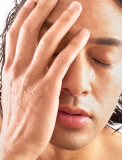Close-up of man with hand on face
