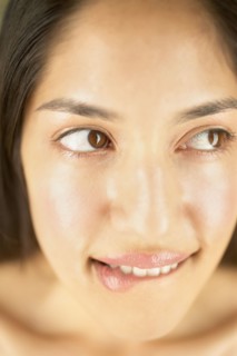 Close-up of woman biting lips