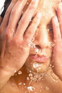 Close-up of man washing face